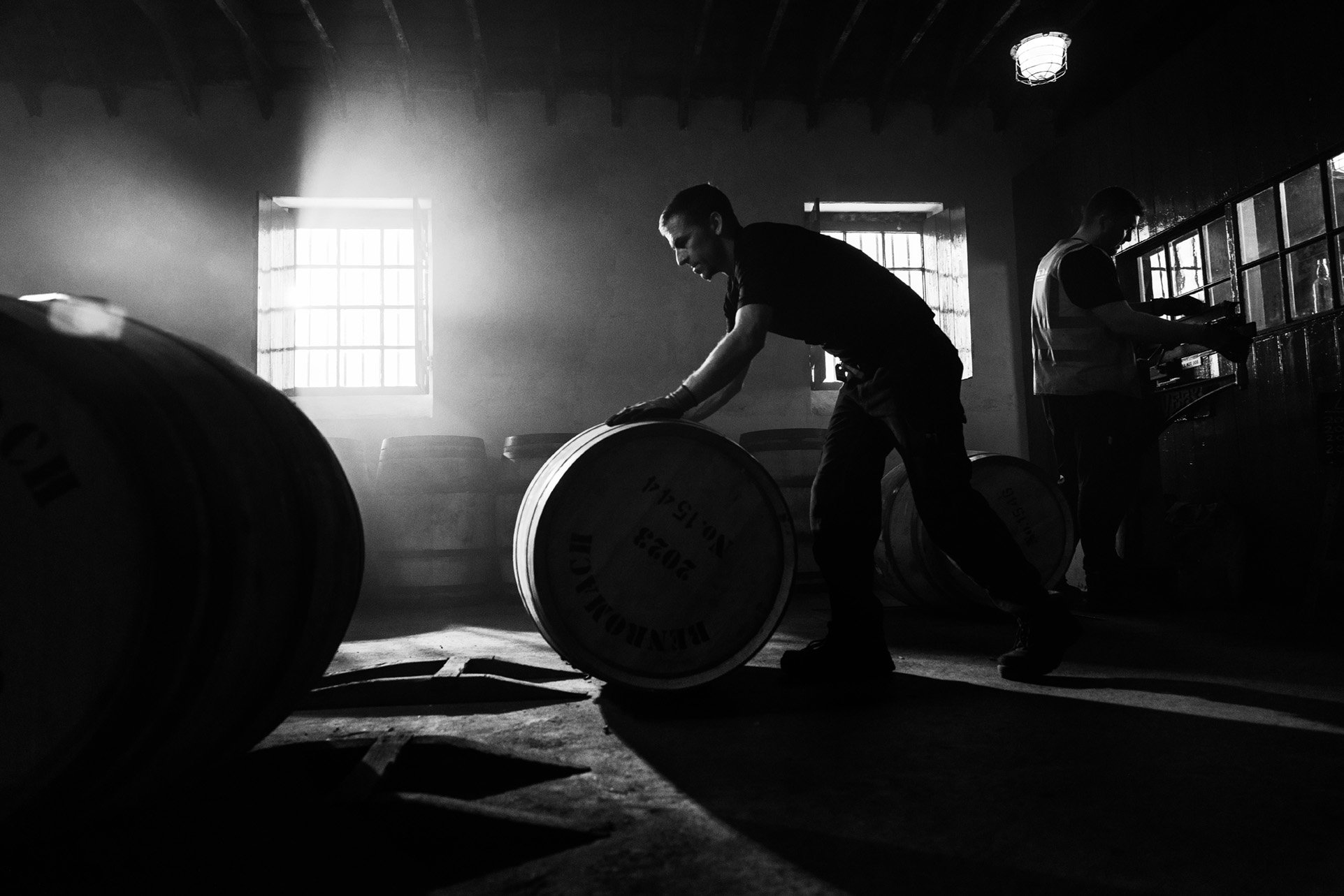 An image of a Benromach cask being rolled into a warehouse